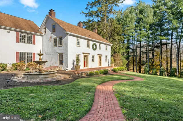 a living room with a fireplace and a wooden floor