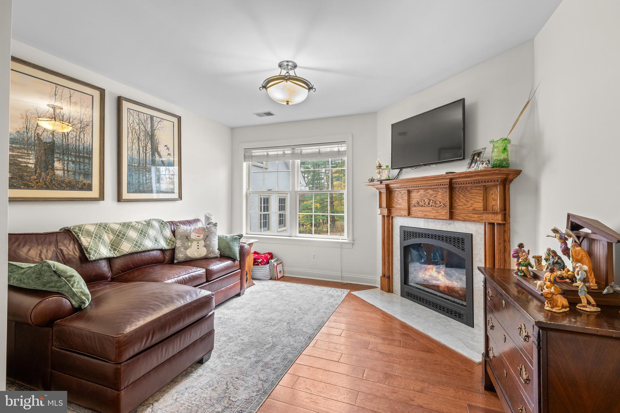 1936 Lenape Road West Chester, PA 19382 - Photo 33 of 72 a living room with furniture a flat screen tv and a fireplace