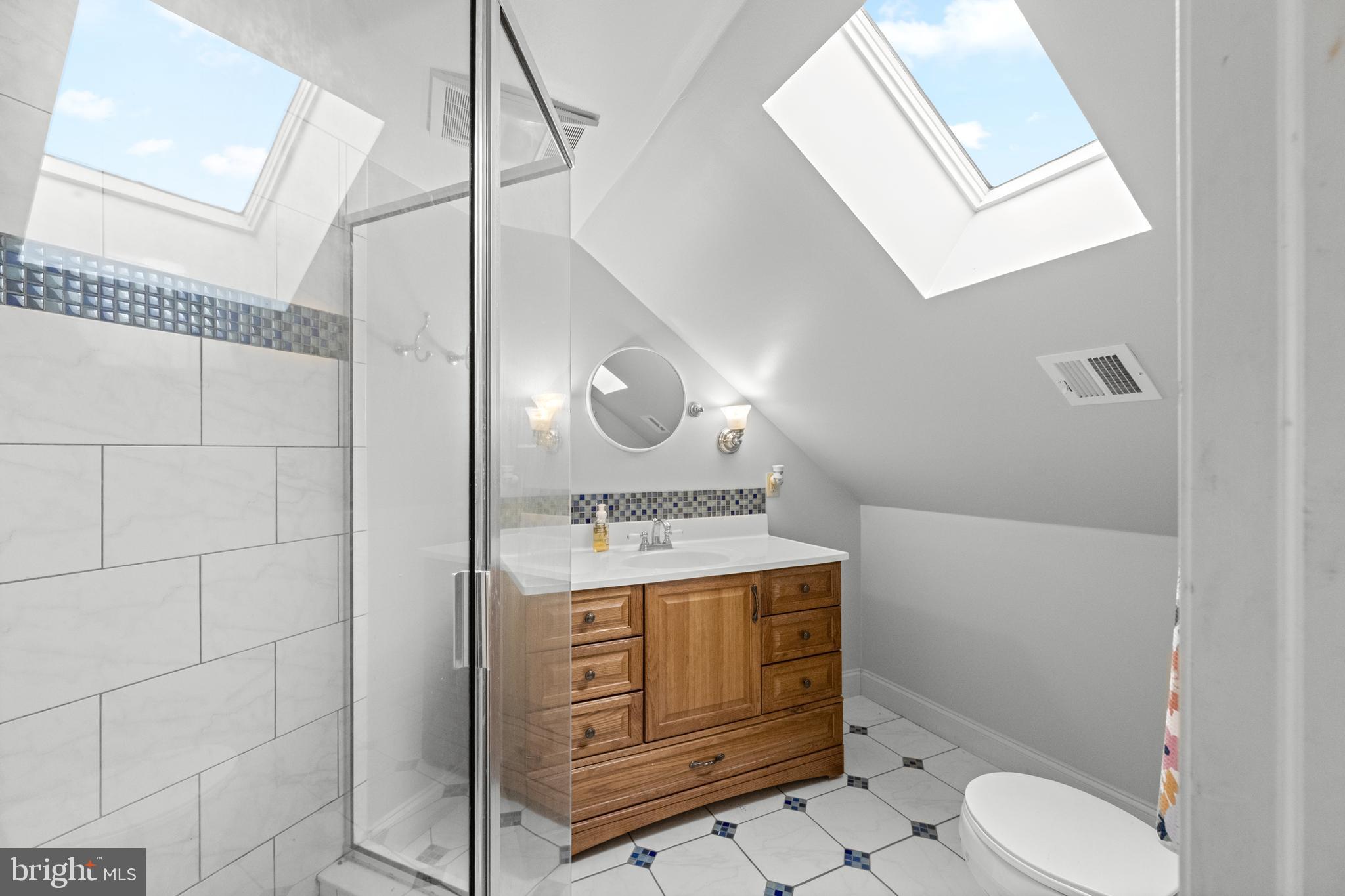 1936 Lenape Road West Chester, PA 19382 - Photo 52 of 72 a bathroom with a toilet a sink and mirror