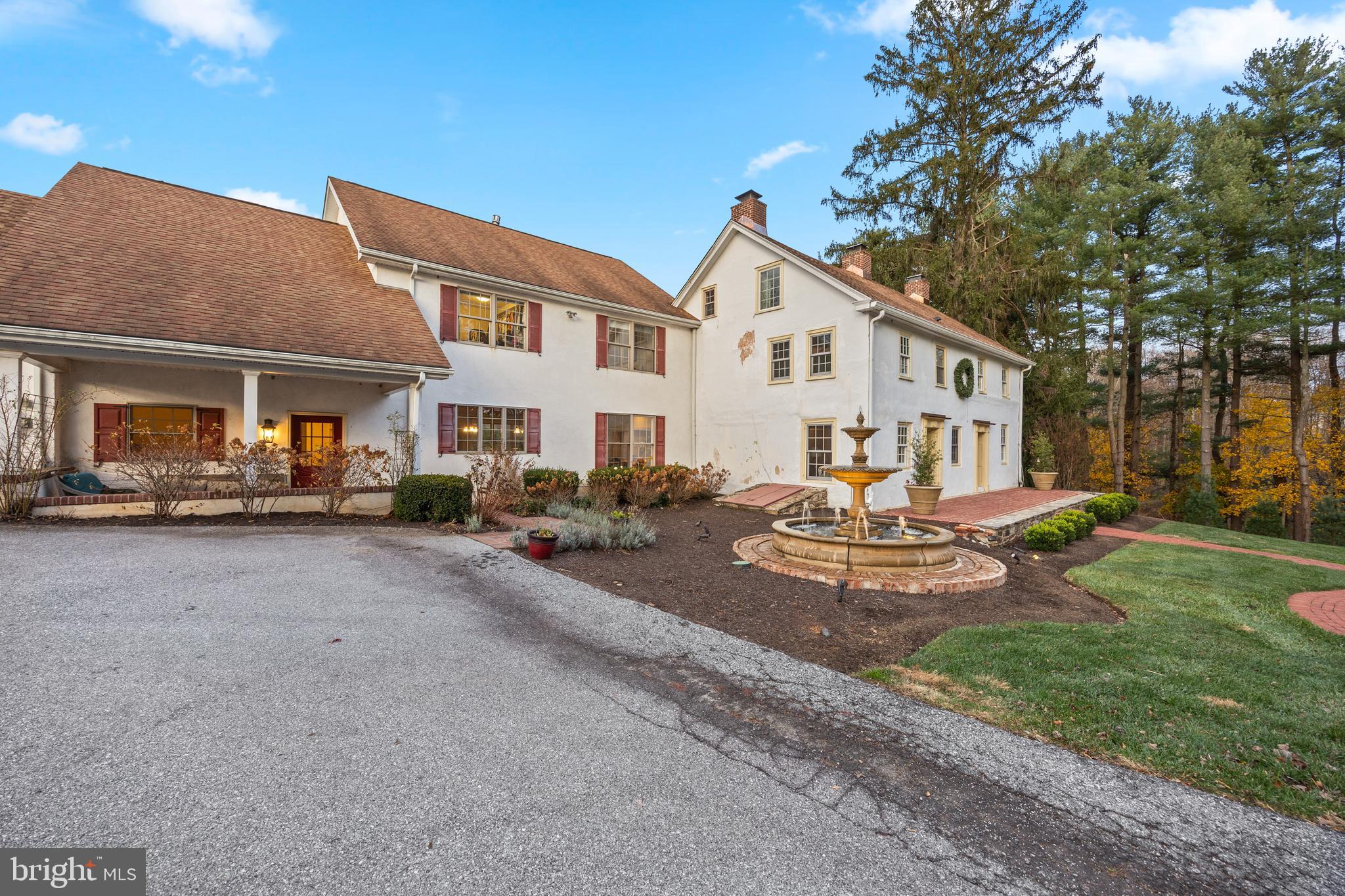 1936 Lenape Road West Chester, PA 19382 - Photo 6 of 72 a view of a white house in front of a yard with plants and trees