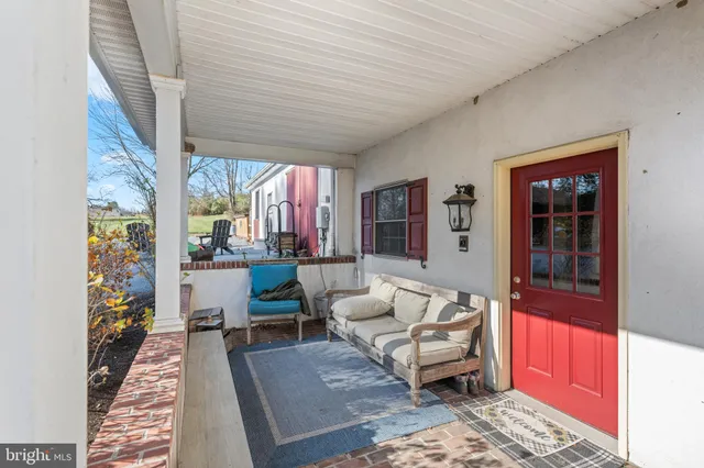 a kitchen with kitchen island granite countertop a table chairs stove and refrigerator