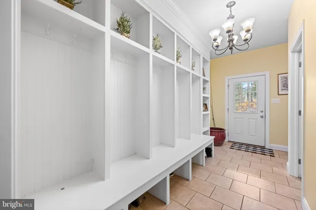 a kitchen with a sink appliances cabinets and a large window