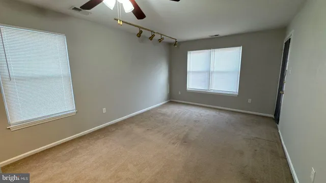an empty room with a empty space and windows