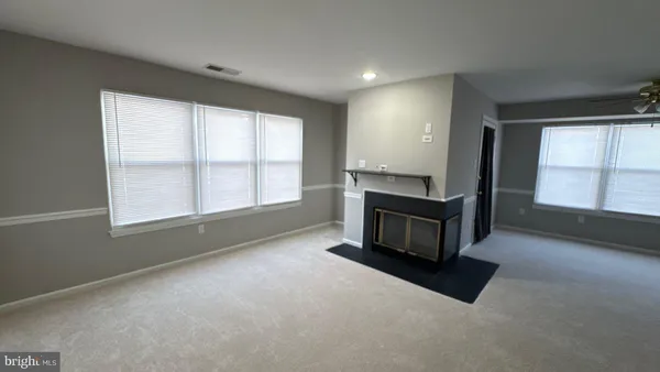 an empty room with furniture and windows