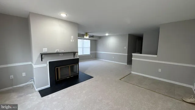 a view of an empty room and fire place