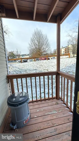 a view of balcony with wooden floor and outdoor seating