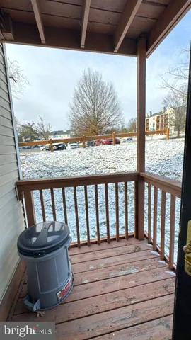 a view of balcony with wooden floor and outdoor seating