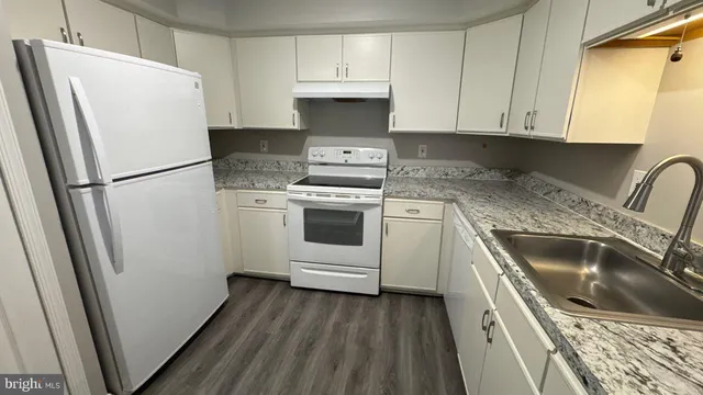 a kitchen with a refrigerator sink and stove
