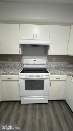 a kitchen with granite countertop a stove and a sink