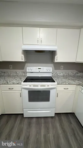 a kitchen with granite countertop a stove and a sink