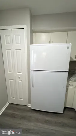 a white cabinet sitting in a kitchen