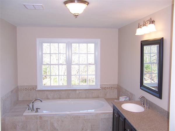 131 Robin Hill Road Groton, MA 01450 - Photo 12 of 22 a bathroom with a granite countertop tub sink and mirror