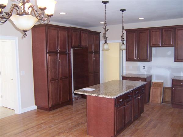 131 Robin Hill Road Groton, MA 01450 - Photo 8 of 22 a kitchen with kitchen island granite countertop wooden cabinets a refrigerator and a sink