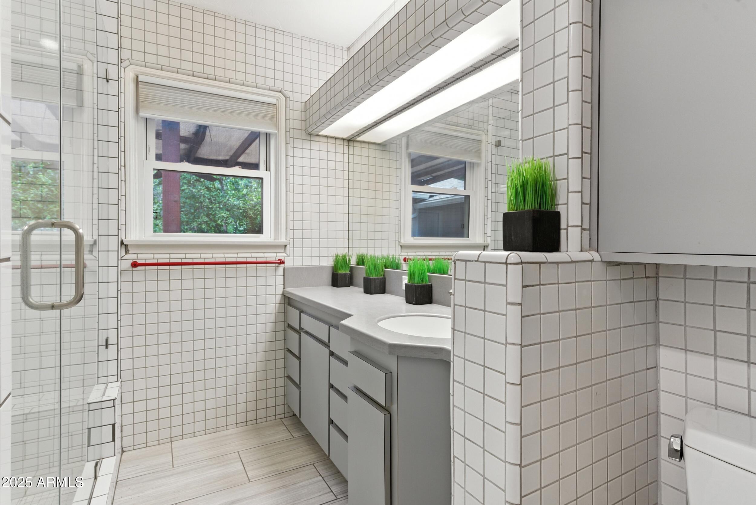 22 East 15th Street Tempe, AZ 85281 - Photo 54 of 84 a bathroom with a sink and a mirror