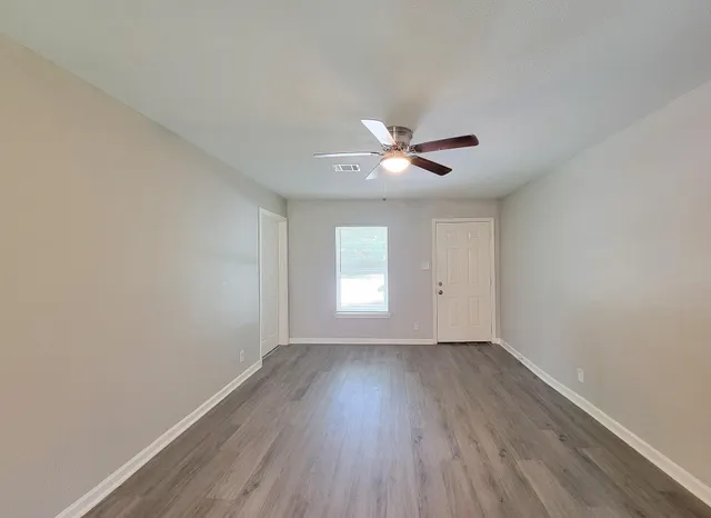 wooden floor in an empty room with a window