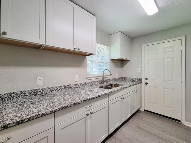 a kitchen with granite countertop cabinets and sink