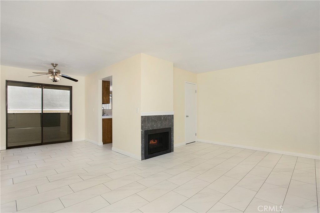 229 West Wilson Street, Unit 8 Costa Mesa, CA 92627 - Photo 3 of 11 en empty room with a fireplace