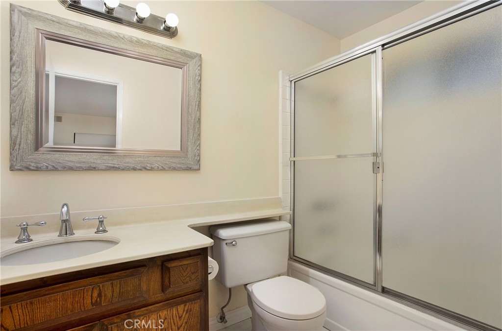 229 West Wilson Street, Unit 8 Costa Mesa, CA 92627 - Photo 8 of 11 a bathroom with a sink a toilet and shower
