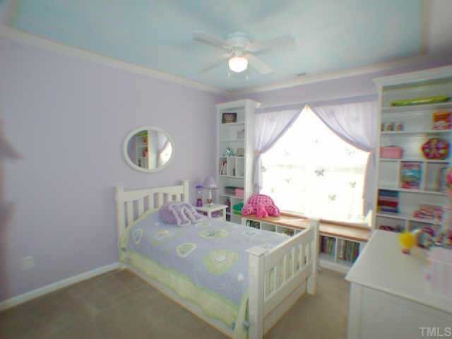 541 Hanska Way Raleigh, NC 27610 - Photo 8 of 10 Bedroom 2 upgraded with ceiling fan, custom built-ins in closet, and custom shelving around the window.