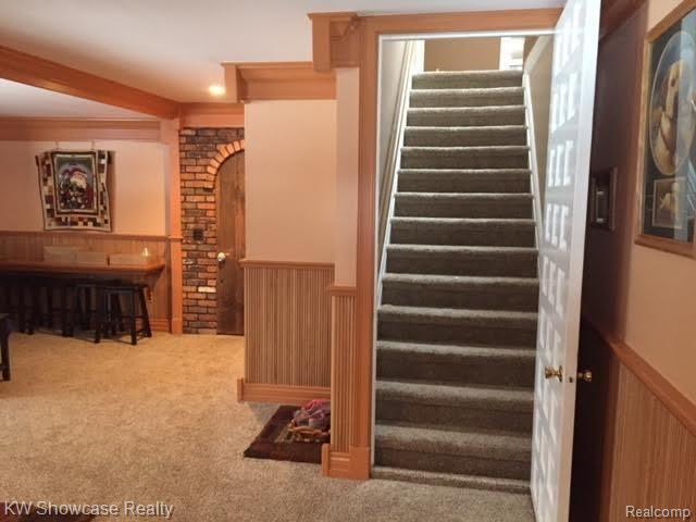 47200 West 11 Mile Road Novi, MI 48374 - Photo 24 of 62 Game/Family RM, Stairs to Upper Lev. Original Brick Wall/Hand Crafted Wooden Accent Door for That Up North Charm.
