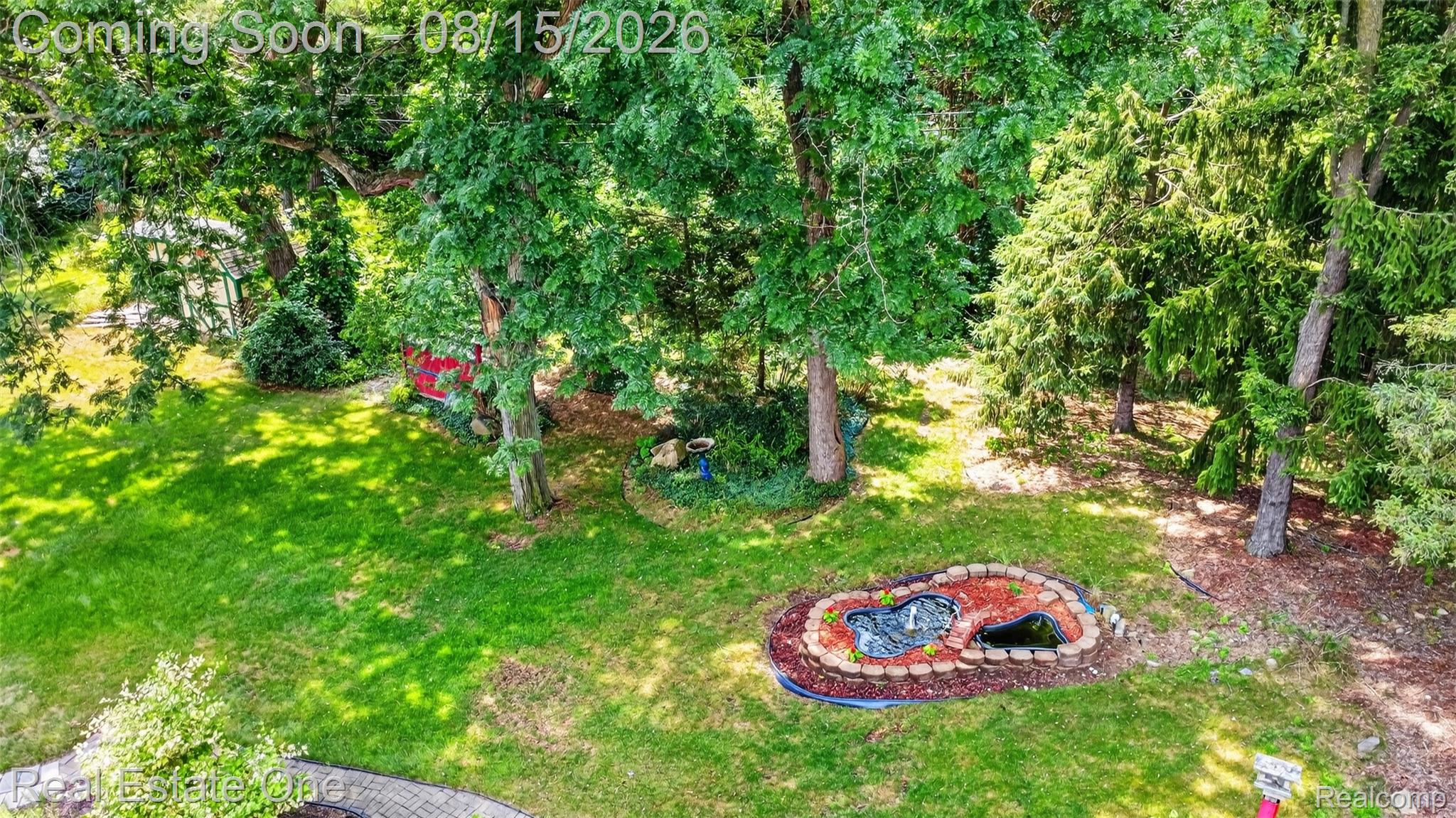 454 South Baldwin Road Oxford, MI 48371 - Photo 59 of 64 Expansive lawn with mature trees and a decorative pond feature