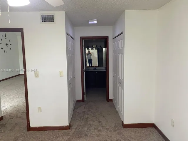 a view of a hallway with wooden shelves