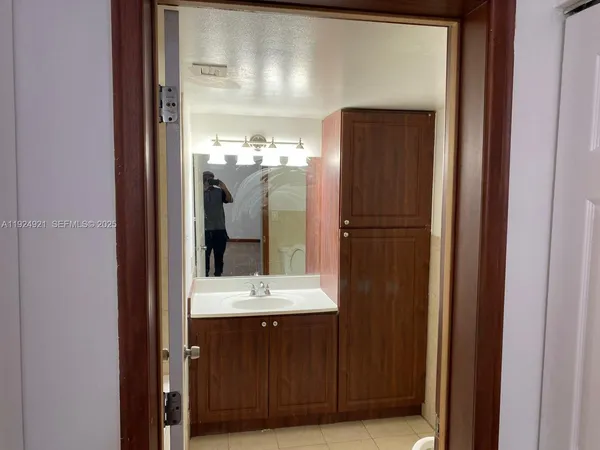 a bathroom with a mirror a sink and a large mirror