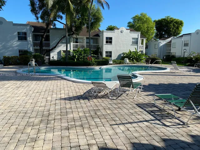 a view of swimming pool with outdoor seating and plants