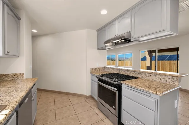 a kitchen with cabinets and chairs