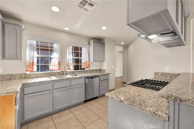a kitchen with cabinets and window
