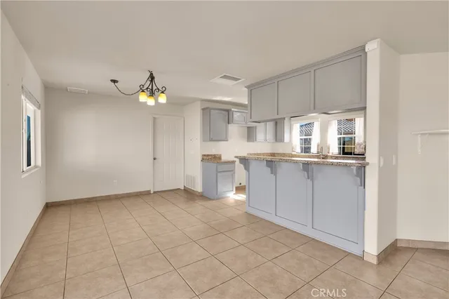 a view of an empty room with a kitchen