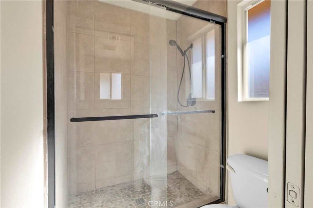57031 Selecta Avenue Yucca Valley, CA 92284 - Photo 21 of 56 a bathroom with a glass shower door