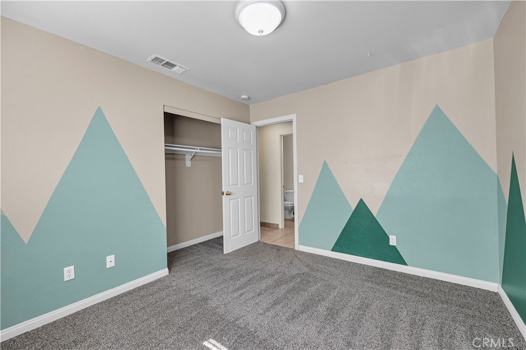 57031 Selecta Avenue Yucca Valley, CA 92284 - Photo 23 of 56 a view of an empty room with wooden floor and a window