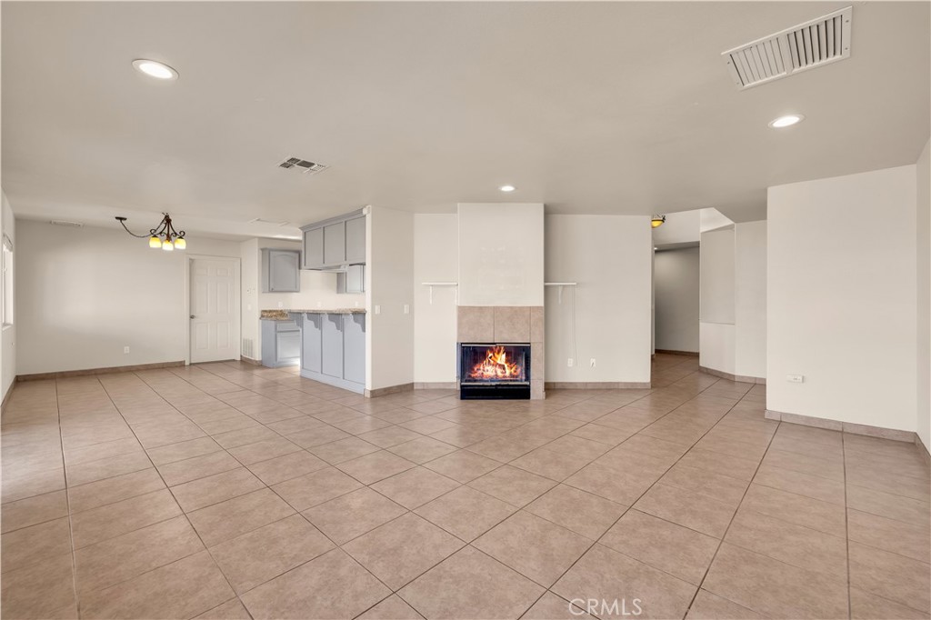 57031 Selecta Avenue Yucca Valley, CA 92284 - Photo 8 of 56 an empty room with a fireplace and cabinet