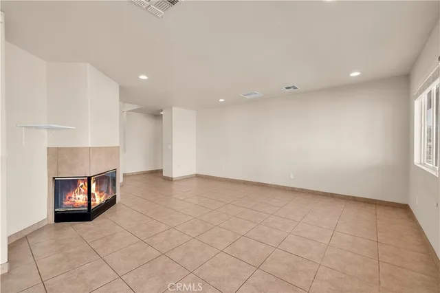 a view of an empty room and a window