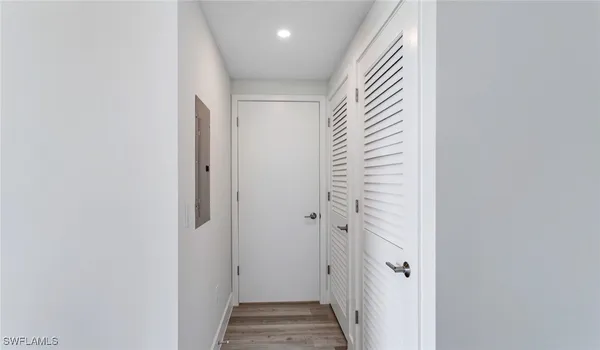 a view of a hallway with wooden floor