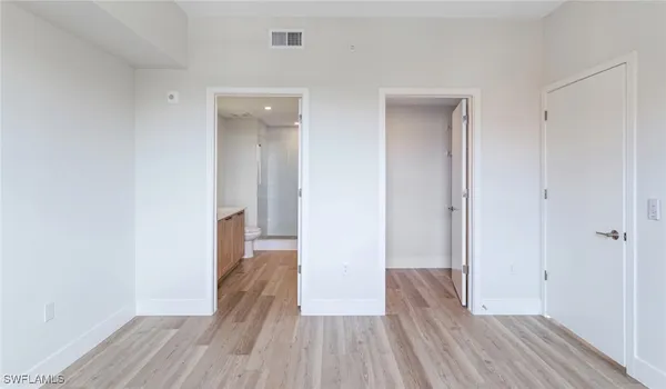 a view of hallway with wooden floor