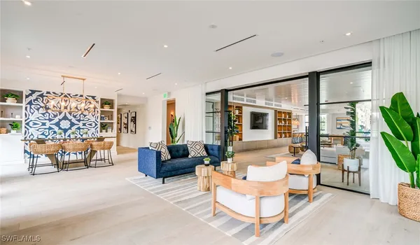 a living room with patio furniture and a flat screen tv