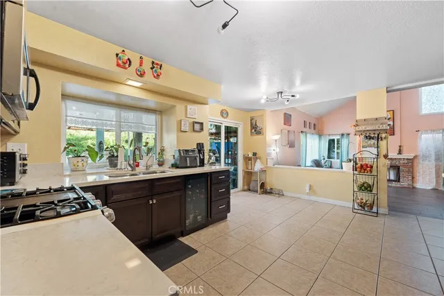 a large kitchen with stainless steel appliances granite countertop a large counter top a stove and a refrigerator