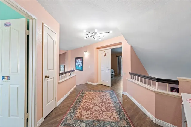 a spacious bedroom with a bed and wooden floor