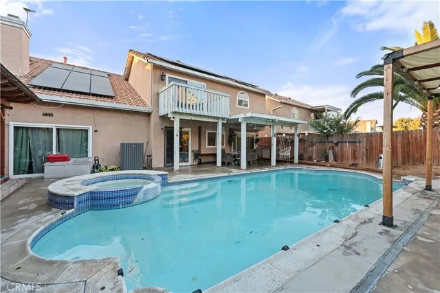 a view of a house with swimming pool and sitting area