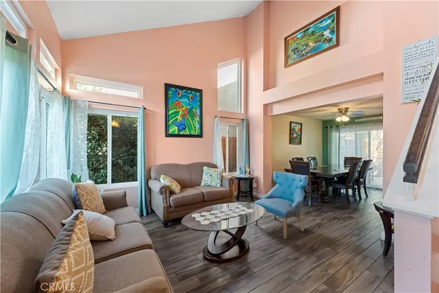 a living room with furniture couches and a large window