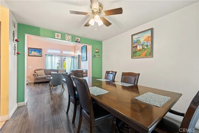 a view of a dining room with furniture and a chandelier