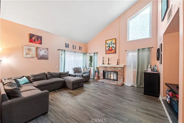 a living room with fireplace furniture and a flat screen tv