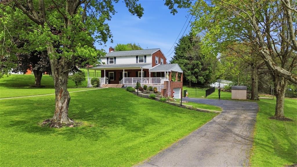 129 Meadowbrook Road Renfrew, PA 16053 - Photo 29 of 45 a front view of a house with a yard table and trees