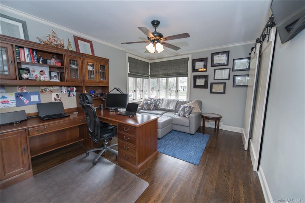 2837 Sharon Road Charlotte, NC 28211 - Photo 11 of 24 a living room with furniture a bookshelf and a window