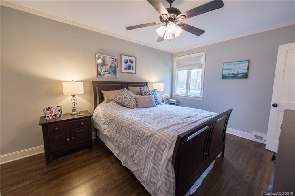 2837 Sharon Road Charlotte, NC 28211 - Photo 15 of 24 a bedroom with a bed and a chandelier