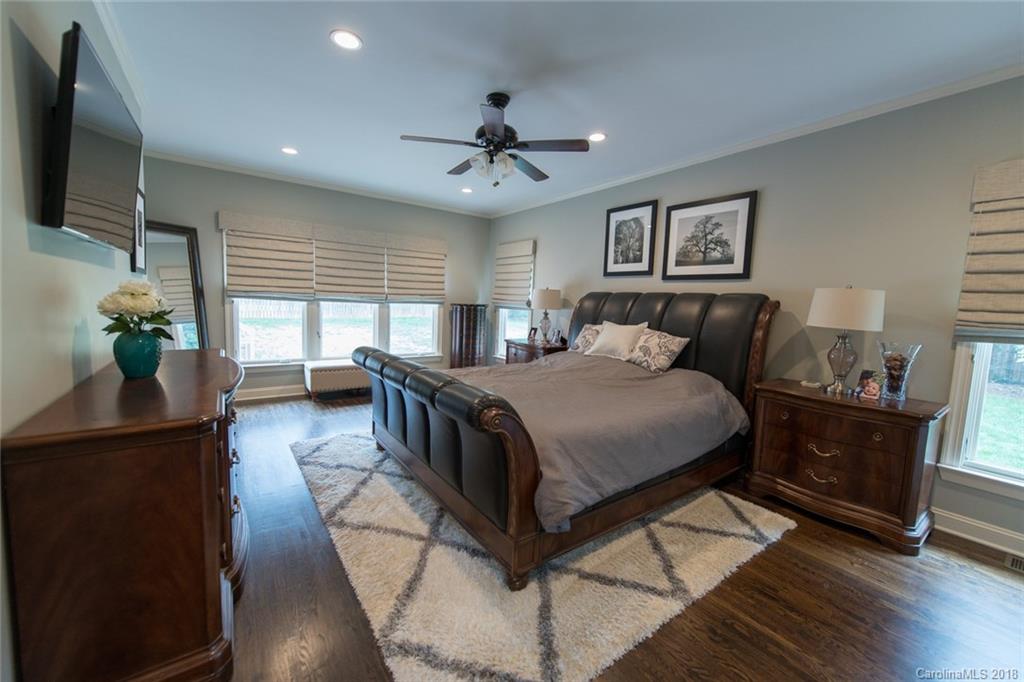 2837 Sharon Road Charlotte, NC 28211 - Photo 18 of 24 a bedroom with a balcony a bed and a flat screen tv