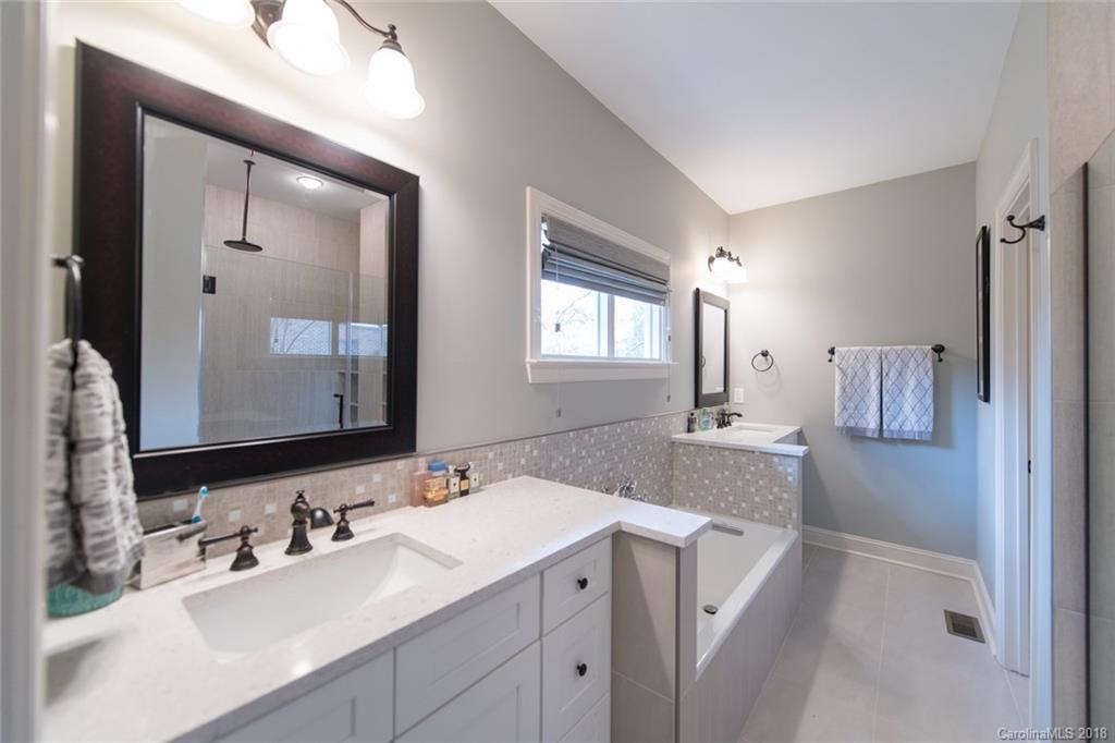 2837 Sharon Road Charlotte, NC 28211 - Photo 19 of 24 a bathroom with a sink and a mirror