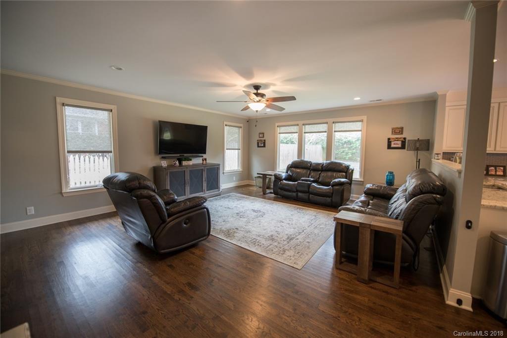 2837 Sharon Road Charlotte, NC 28211 - Photo 9 of 24 a living room with furniture a flat screen tv and wooden floor